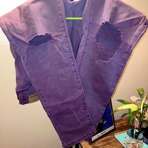 Stretch High-Waist denim. Knee rips.